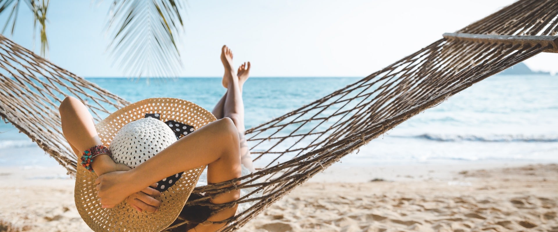 Traveler asian woman relax in hammock on summer beach Thailand